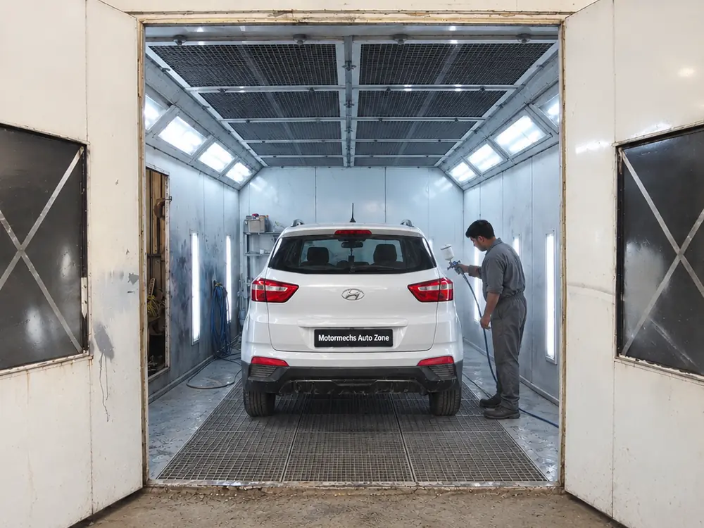 White Hyundai Creta in the paint booth with a painter at work