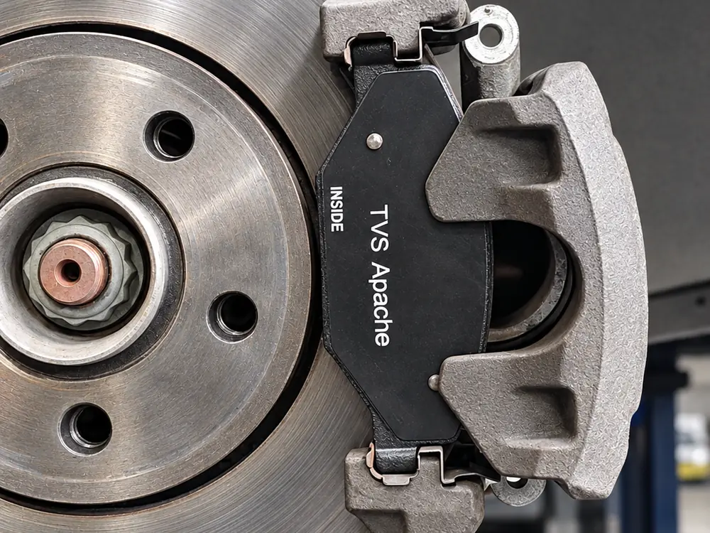 New brake pads fitted in the caliper over the disc