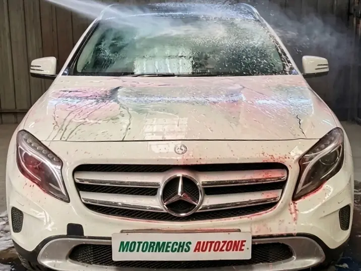 White Mercedes-Benz GLA being rinsed during a foam wash