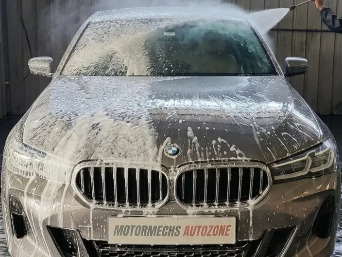 BMW covered in snow foam during a wash