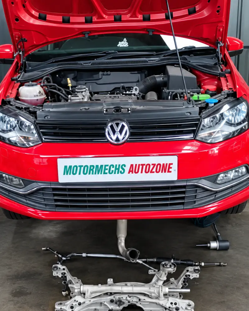 Red Volkswagen Polo in the workshop with its steering and suspension parts laid out